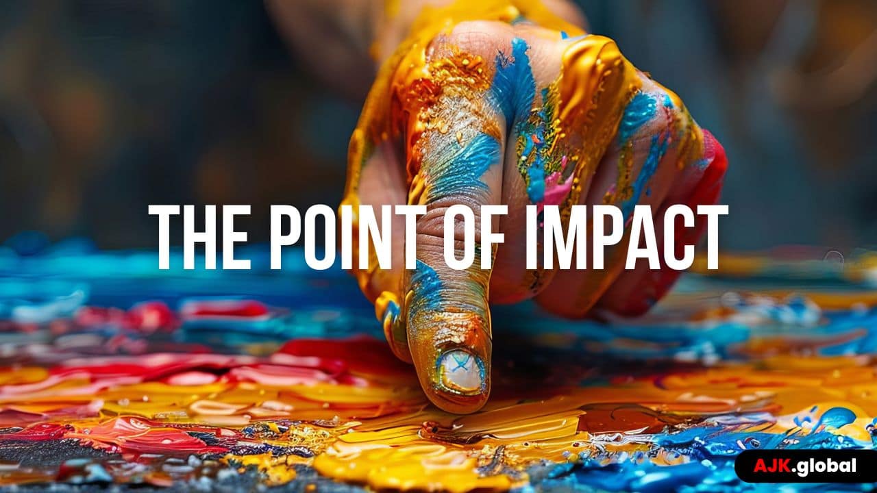 The Point of Impact – AJK Brightly coloured photo of a human finger pointing to a painting full of colours